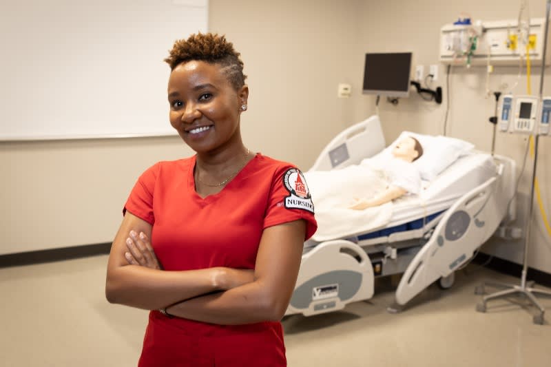 UIW nursing student posing in front of hospital bed with arms crossed