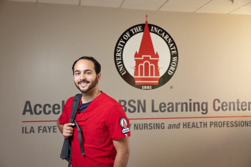 UIW nursing student in red scrubs and backpack