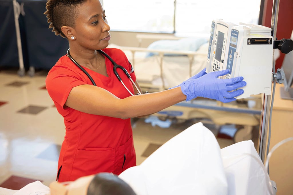 Nursing student in scrubs in a clinical setting