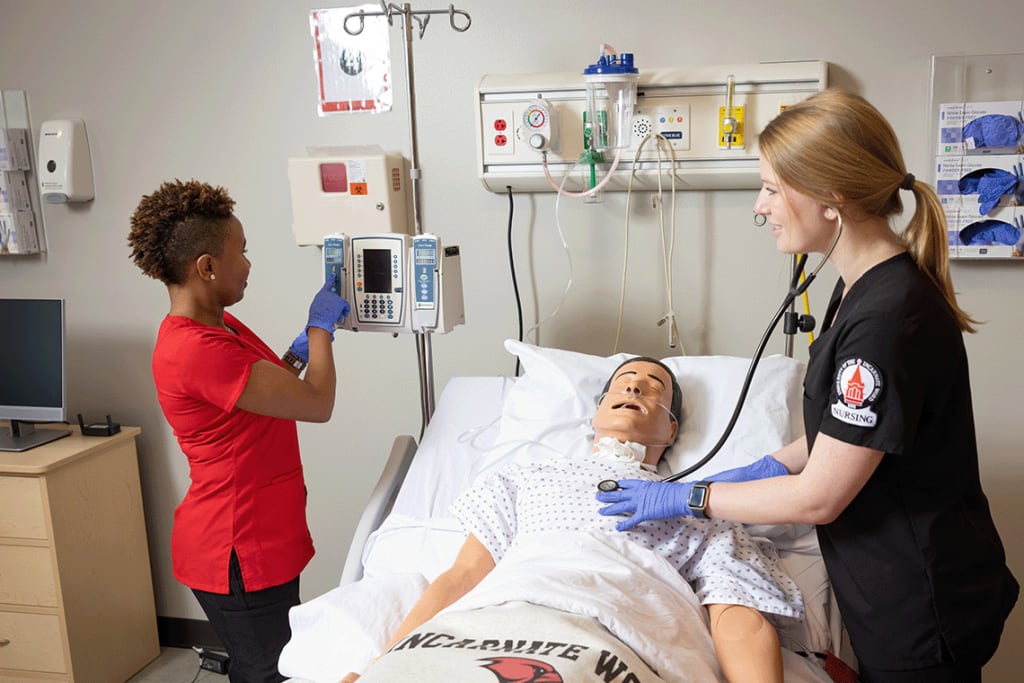 2 UIW nursing students working together in a lab setting