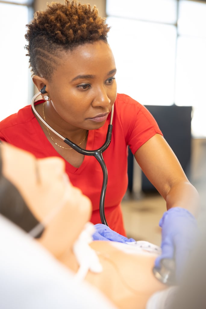 UIW nursing student in lab setting wearing a stethoscope