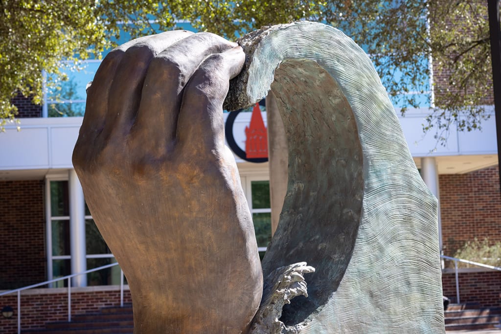 UIW campus shot of hands and rocks making a heart