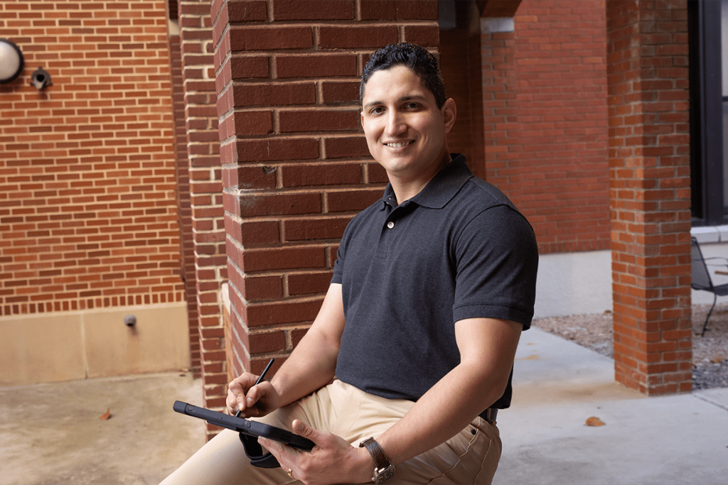 UIW nursing student smiling while holding iPad