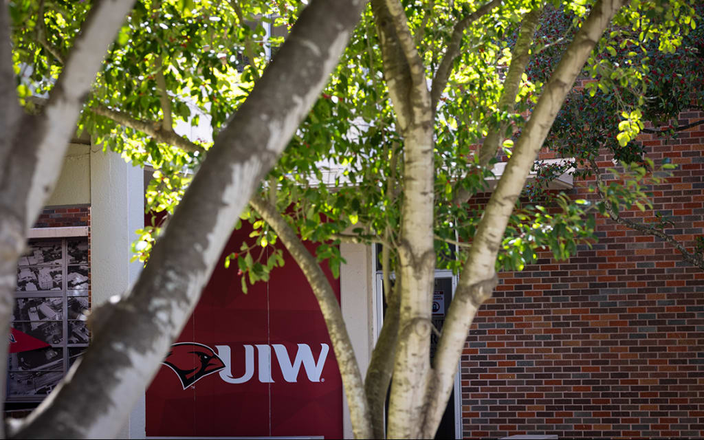 UIW logo painted on window of a building