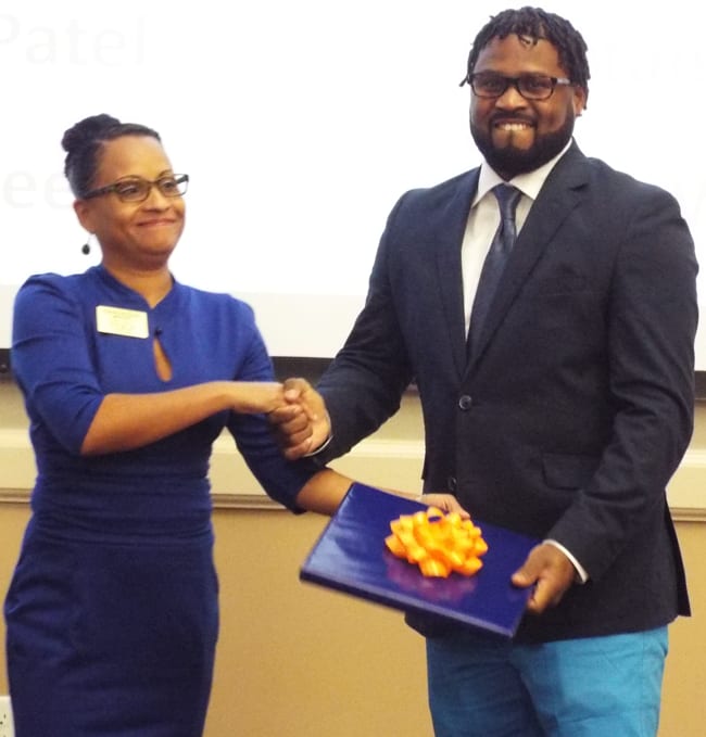 Utica College ABSN student, Lee, receiving an award