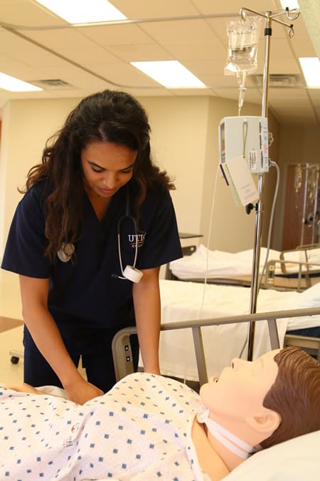 Utica nursing student with simulation manikin