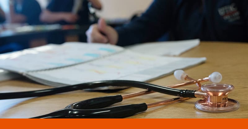 Student preparing for nursing school with stethoscope on table