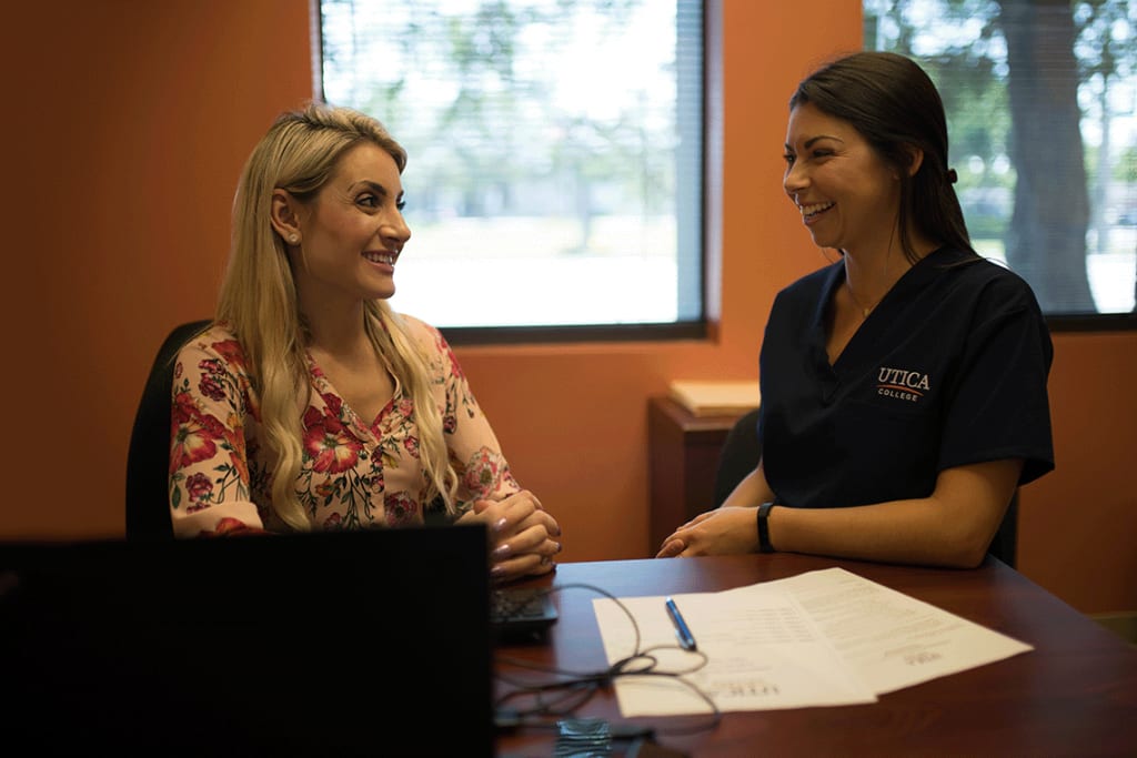 Utica student chatting with admissions advisor