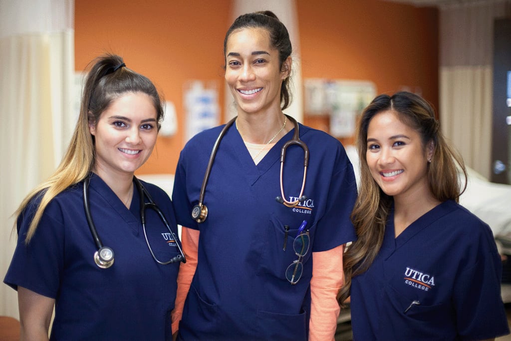 3 Utica student smiling at the camera