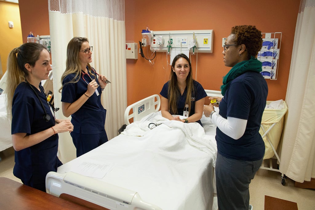 Nursing students and instructor practicing in a clinical setting