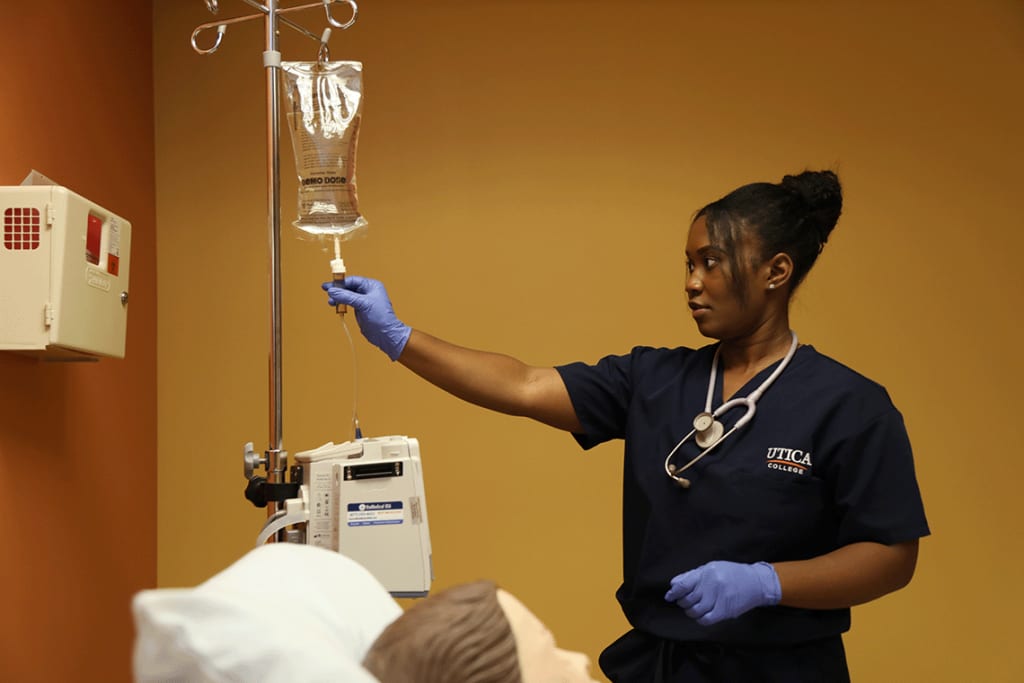 Utica student working on a manikin