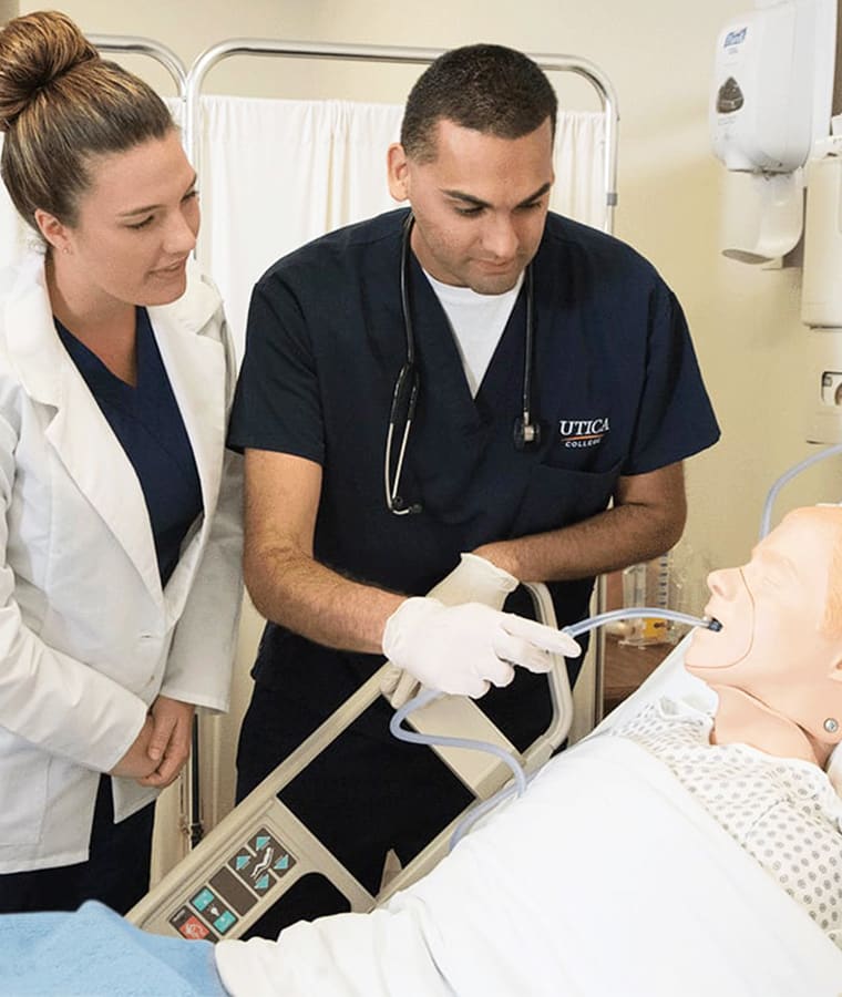 utica nursing students practicing on manikin