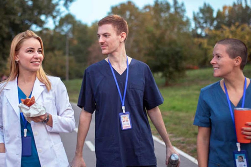 three nurses walking outside