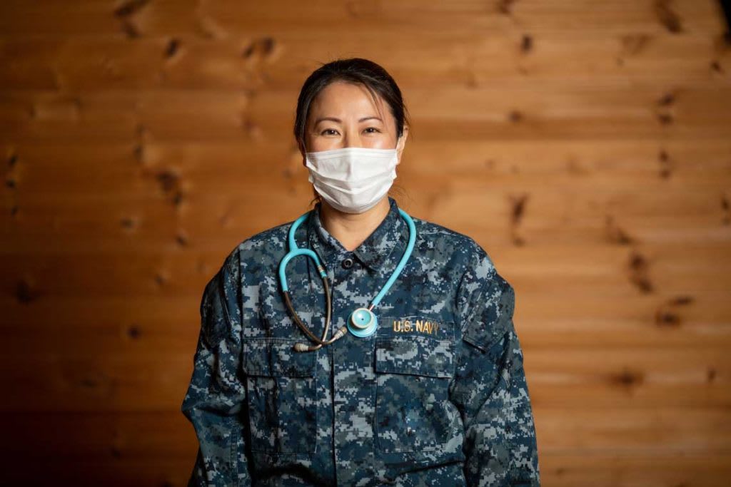 veteran nurse wearing camouflage uniform and a face mask