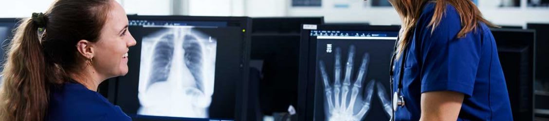 nurses looking at X-Ray scans