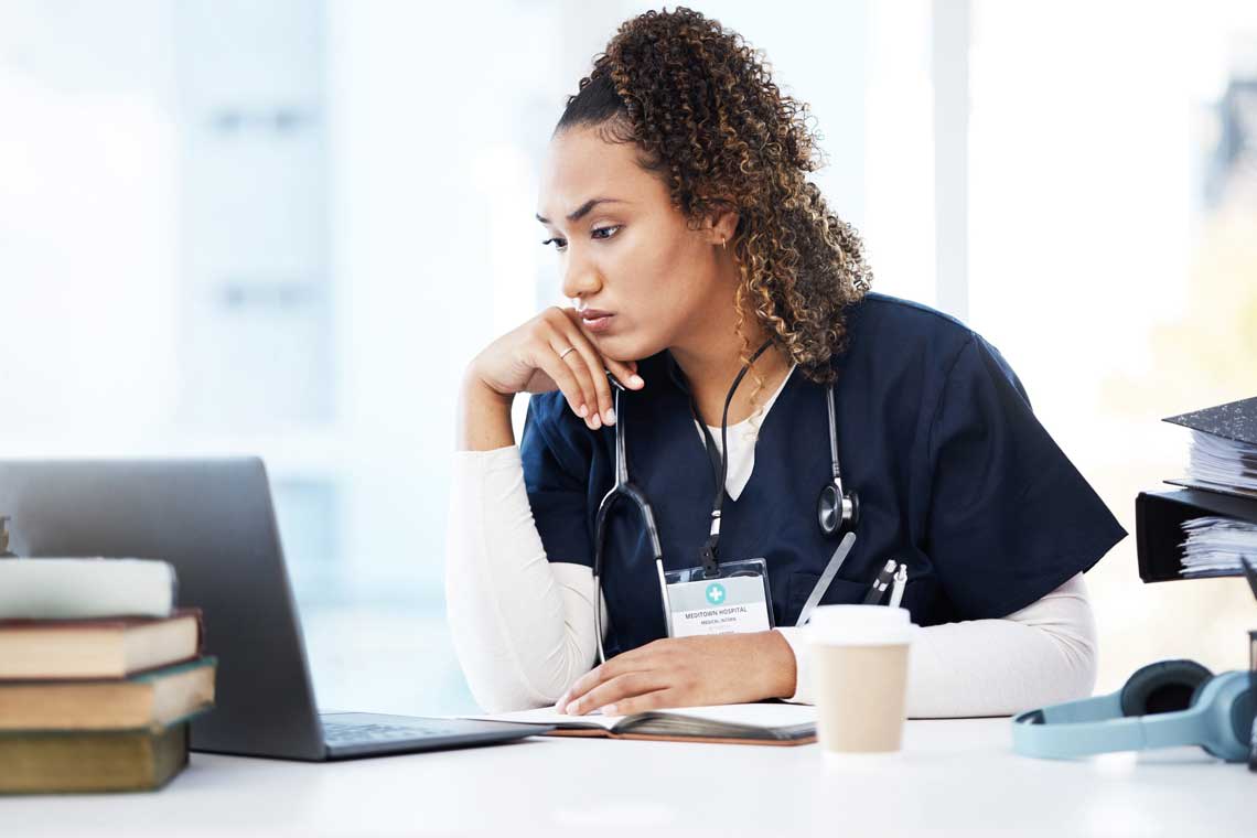 nurse looking at laptop