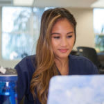 In Their Own Words - Utica ABSN Students Explain Why Nursing School is Hard - Student working on laptop