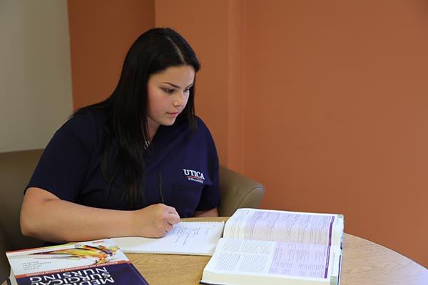 Utica ABSN student studying