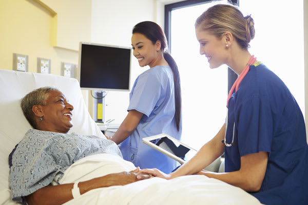 Nurses working with patient in hospital