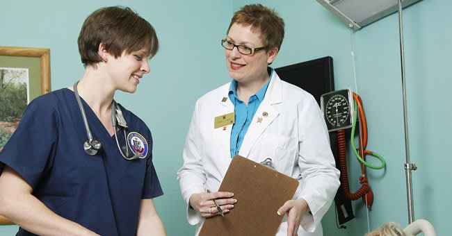 Faculty working with nursing student