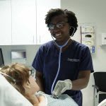 Xavier ABSN graduate Ayana using stethoscope