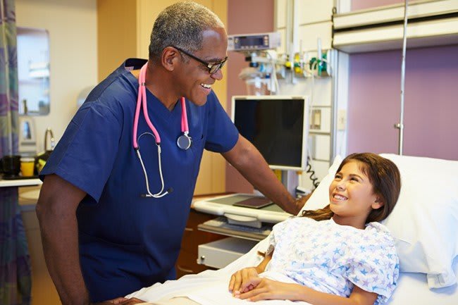 Xavier absn student smiling with patient in lab setting