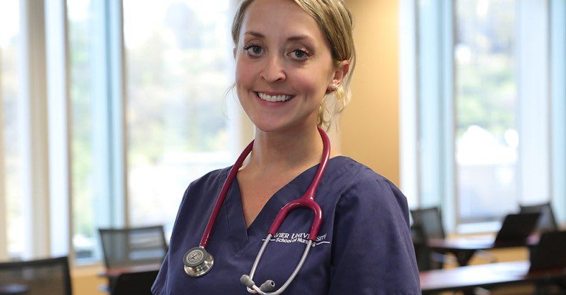 Xavier nurse with stethoscope smiling at camera