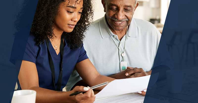 Nurse and man looking at notes together