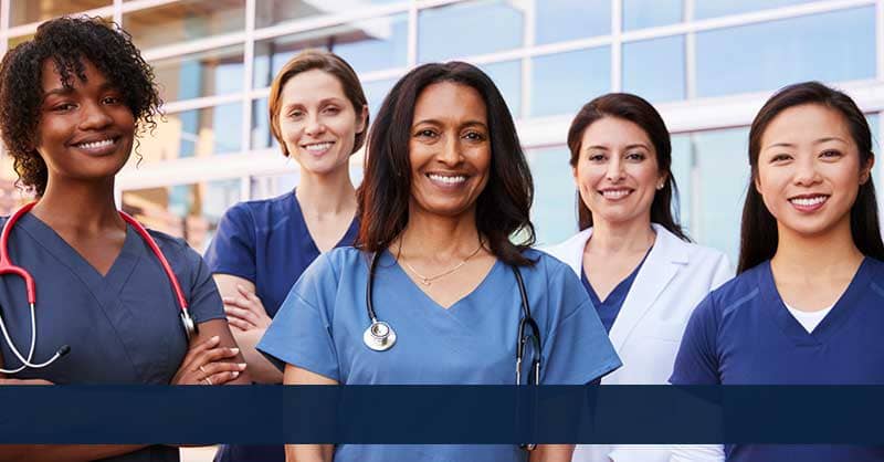 Five nurses standing together outside