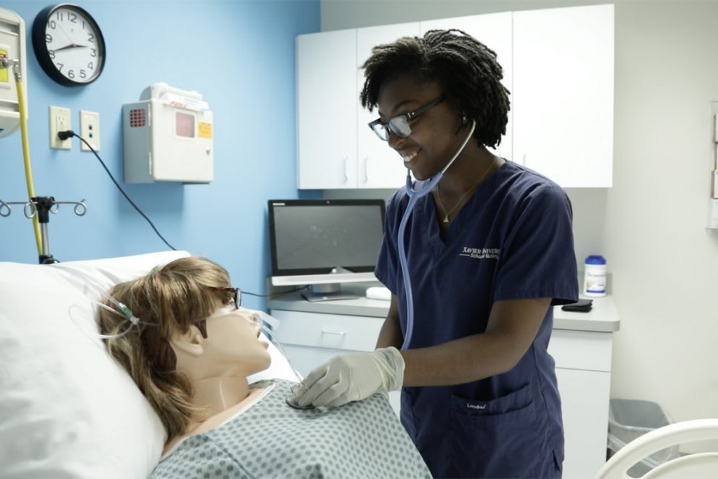 xavier student working with manikin