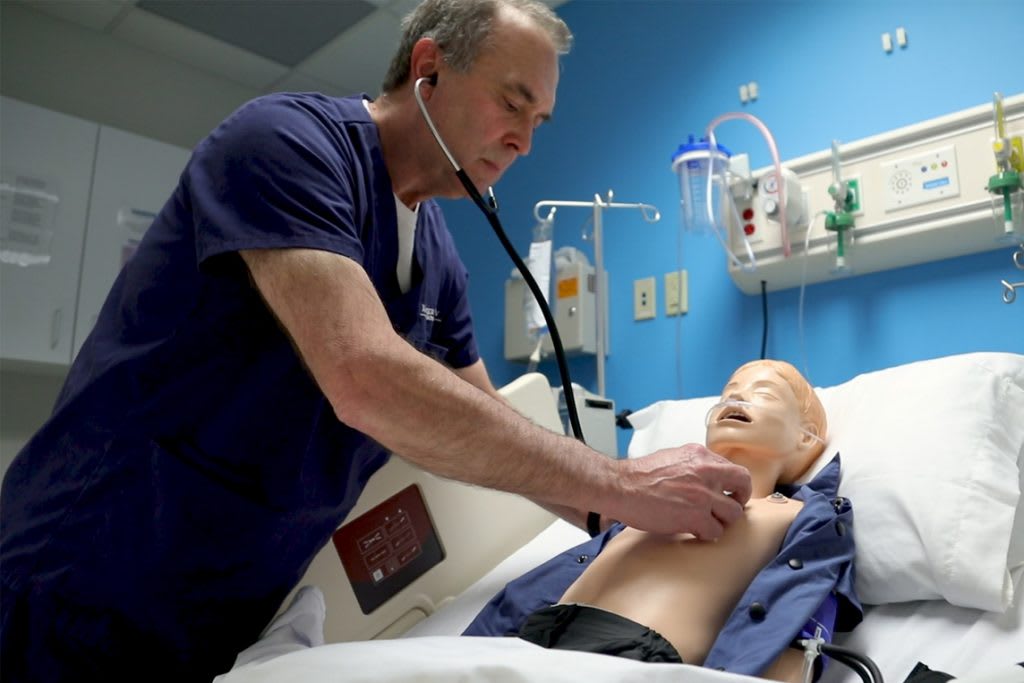 Xavier student working on manikin