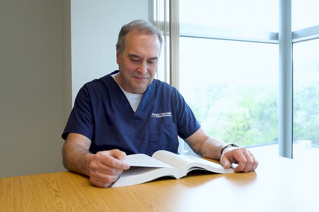 xavier absn student reading textbook