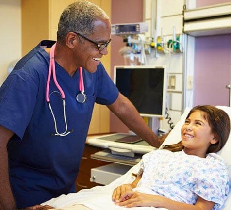 nurse with a child in bed