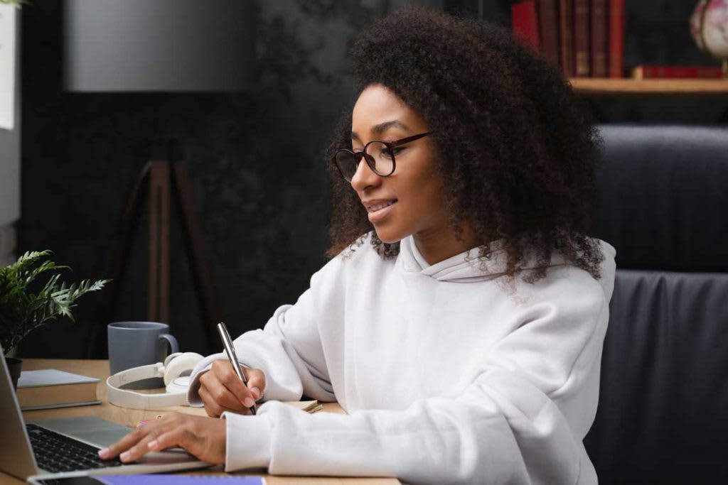 woman sitting at desk with laptop