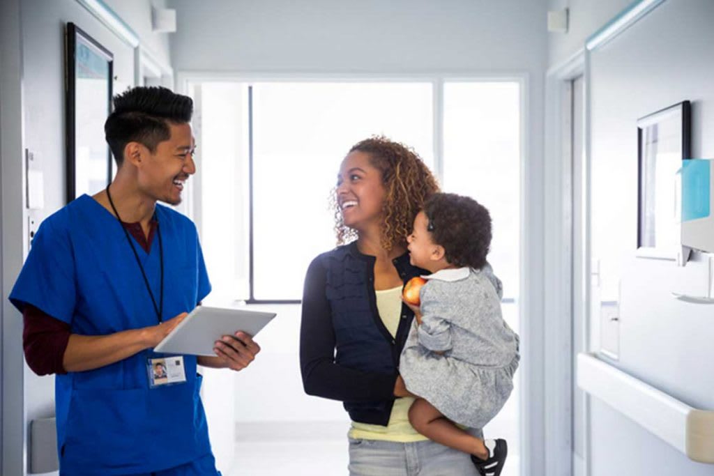 nurse walking in hallway with patient