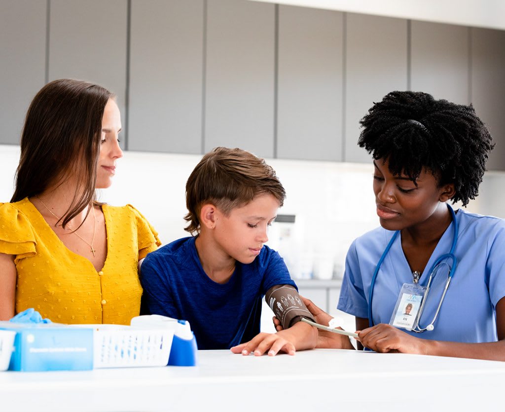 nurse with patient and patientâs mother