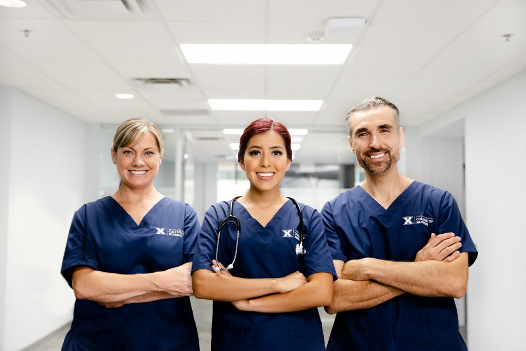 3 nursing students posing in hallway