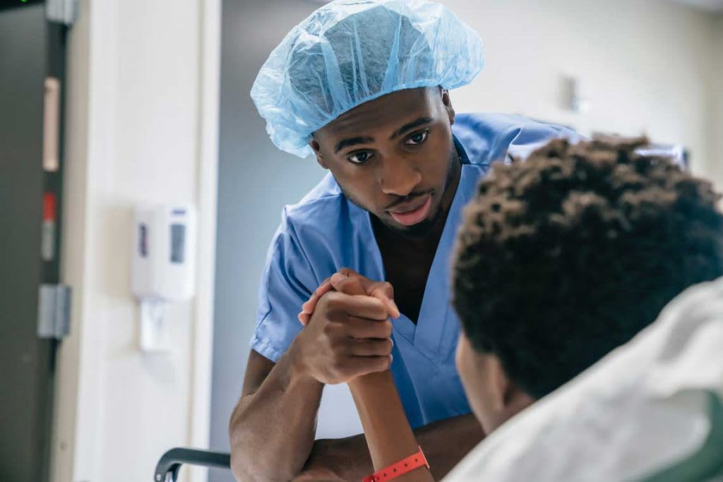 nurse holding patient's hand