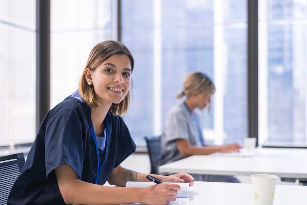 nurse sitting in class looking at camera