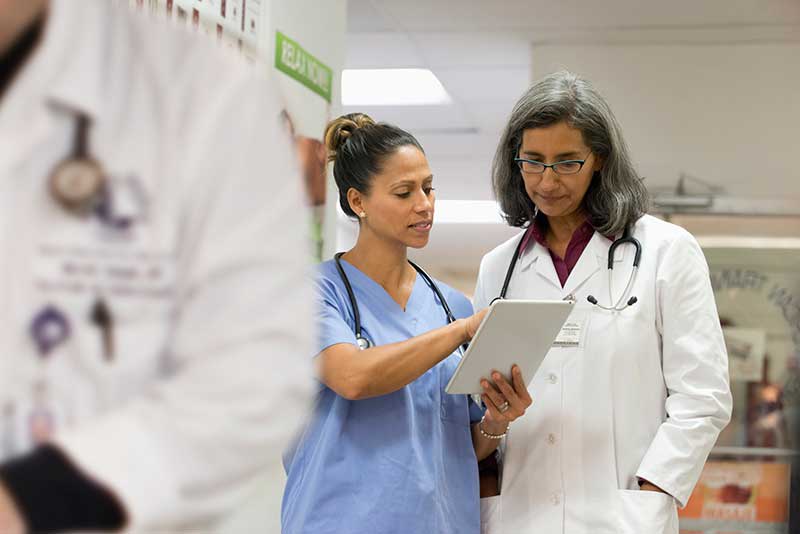 nurse speaking with doctor in hospital