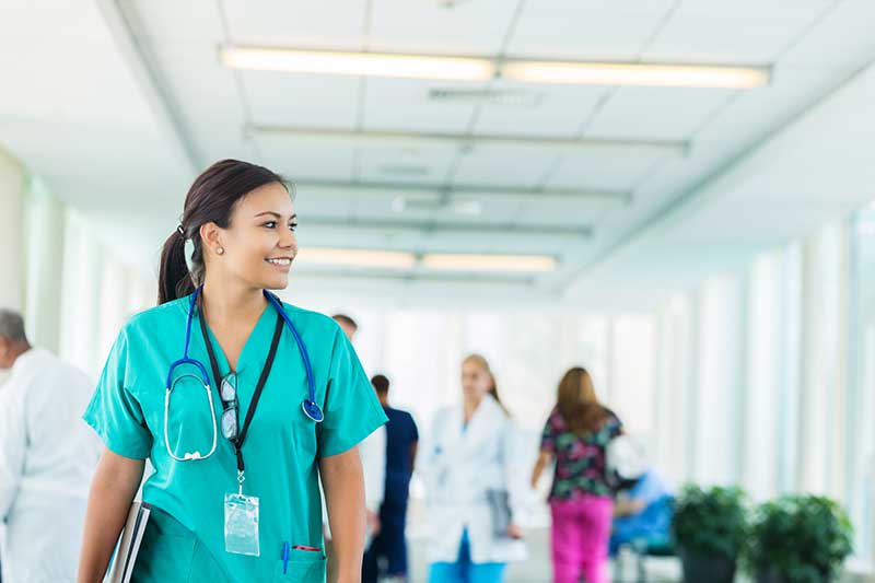 Nurse walking through hallway