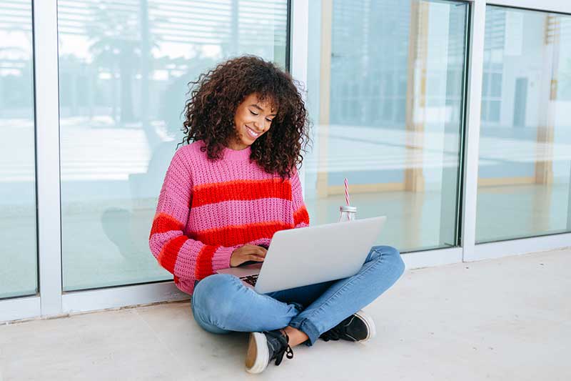 woman using laptop while sitting outside