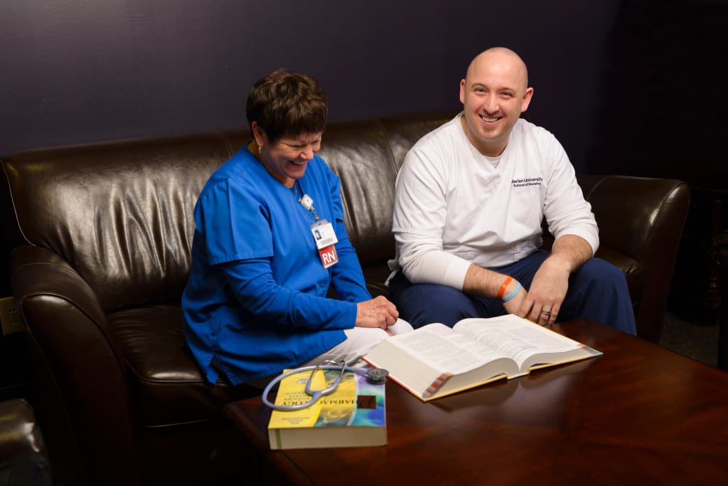 Two people on couch laughing