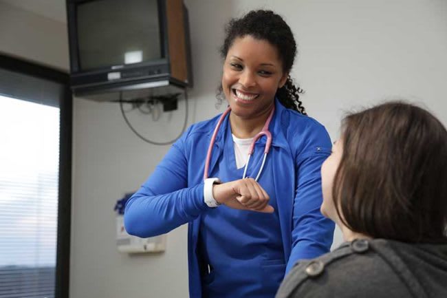 nurse testing a patient's pulse