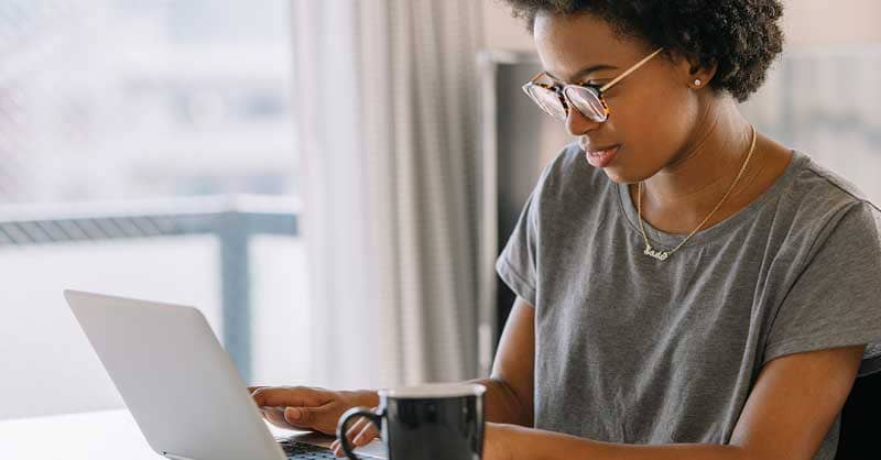 woman working at desk with a laptop