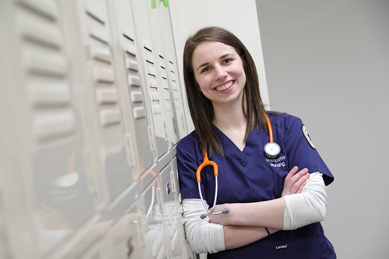 Marquette MSN student Shelby standing by lockers