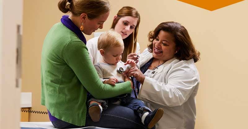 Nurse attending to patient with child