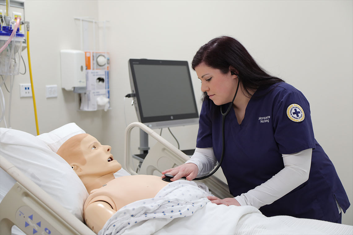 nursing student practicing on manikin