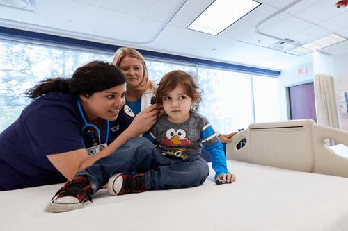 two nurses checking a patient