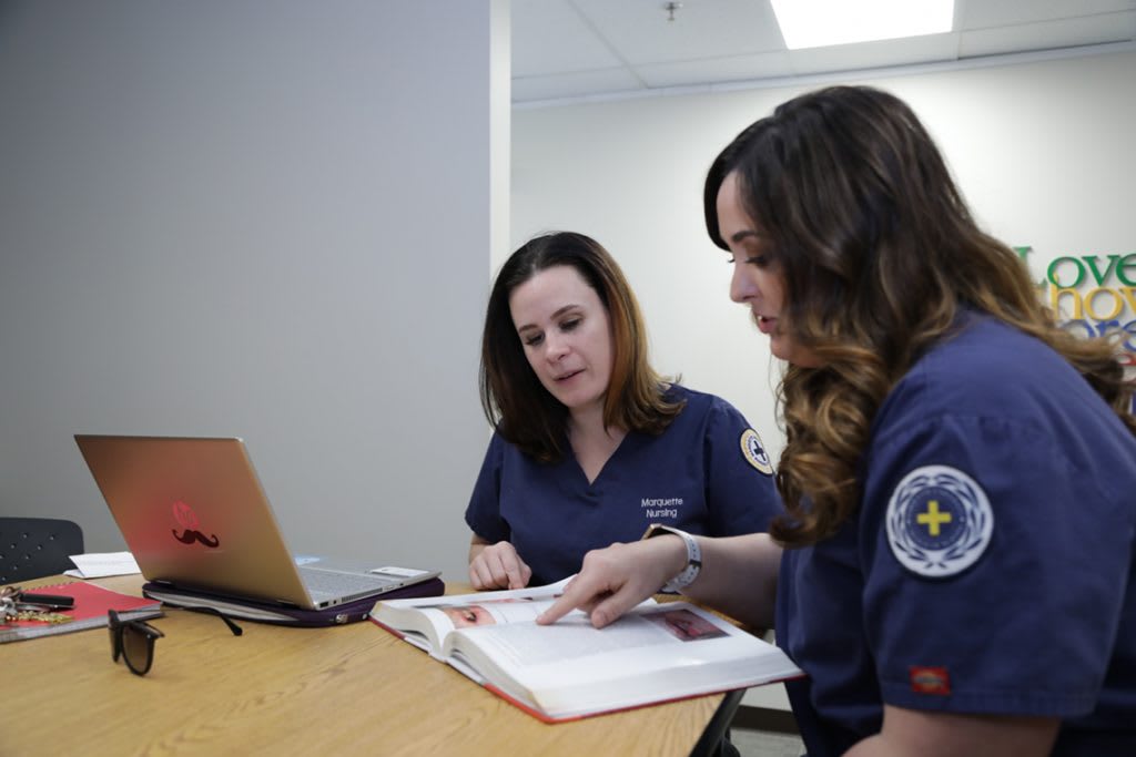 two nursing student studying at a table